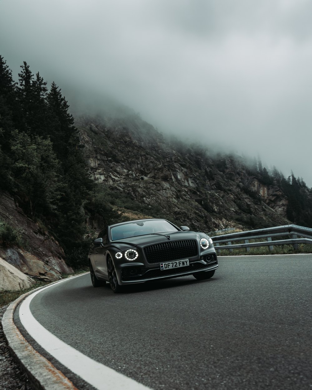 Bentley Flying Spur Speed on a mountain road under low cloud