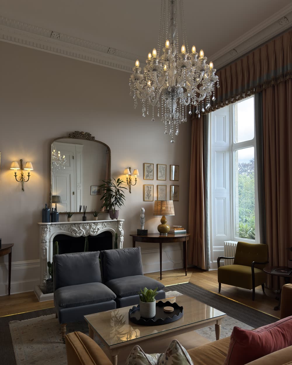 Country house drawing room with a crystal chandelier and a marble fireplace